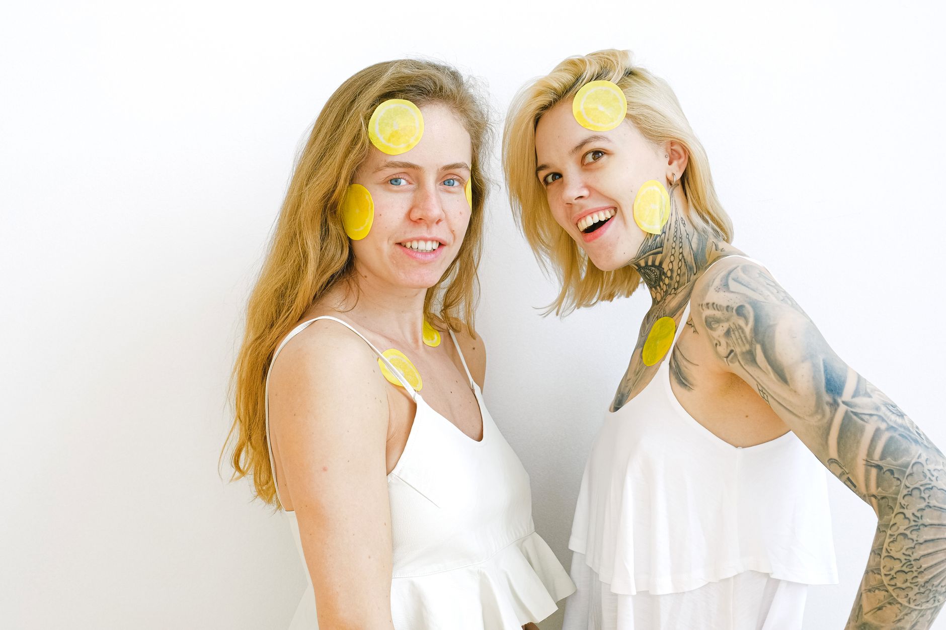 A sleek yellow silicone vibrator surrounded by peeled bananas on a bright yellow background