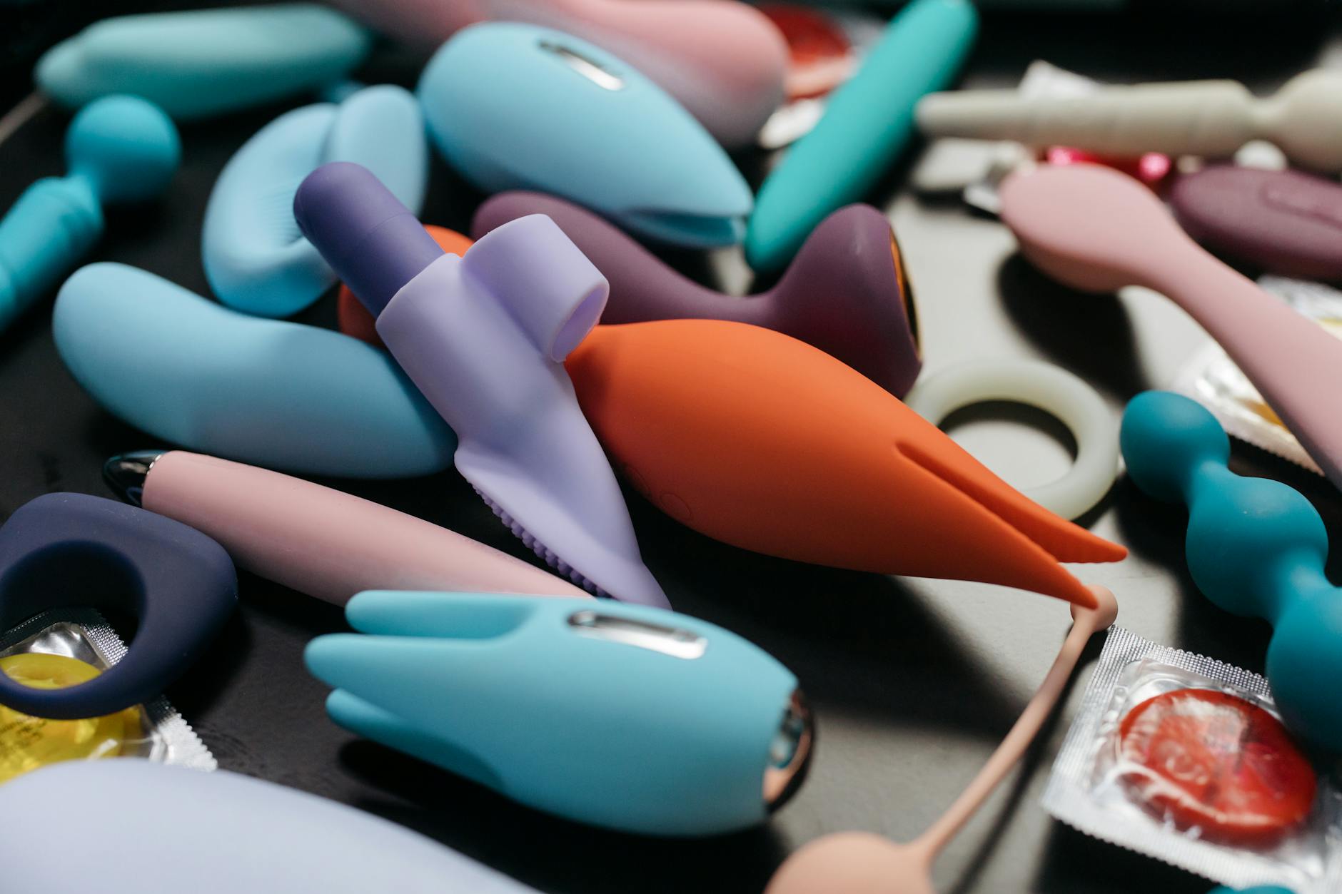 A close-up of colorful vibrators and adult toys arranged together