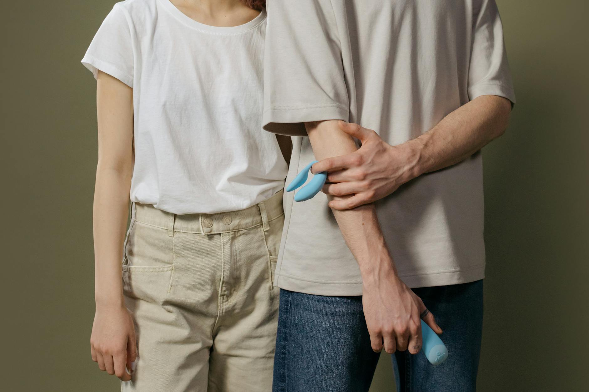 Woman holding blue and pink silicone vibrators in a peaceful, self-directed moment